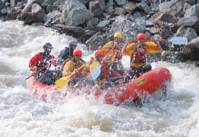 guests getting splashed during Clear Creek whitewater rafting tour