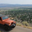 Jeep driving on road overlooking residential area outside Red Canyon Colorado Jeep Tours