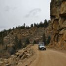silver jeep driving down mountain Colorado Jeep Tours